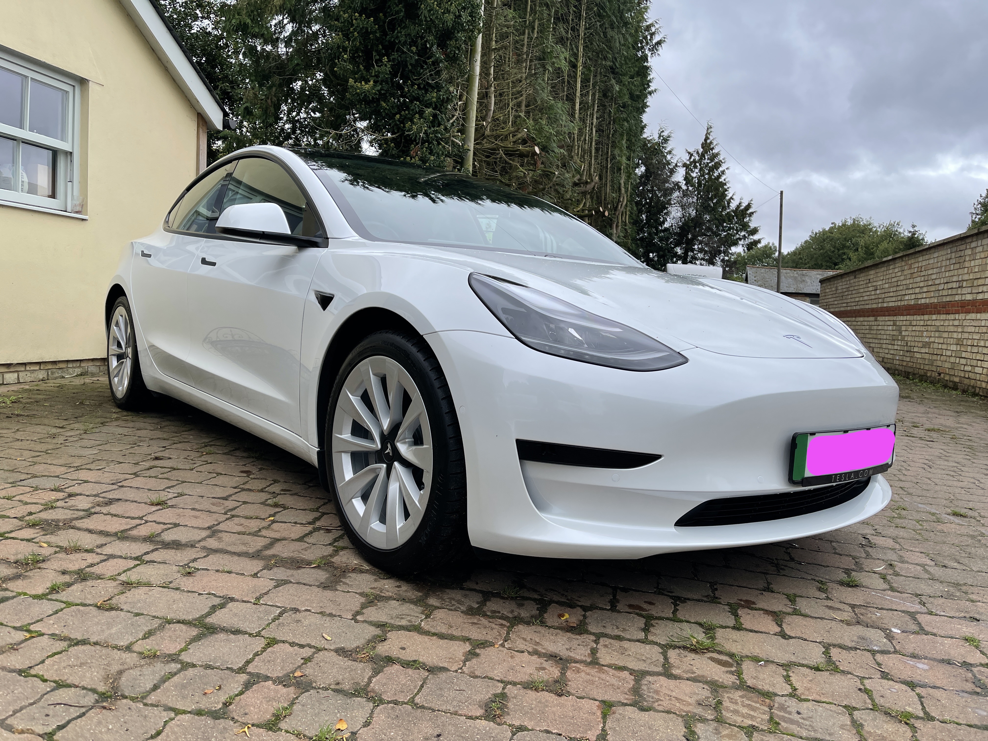 A photo of my new Tesla Model 3 in white with sports wheels